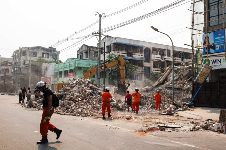 Rescuers search for survivors at the site of a collapsed building on Sunday following an earthquake in Mandalay, Myanmar