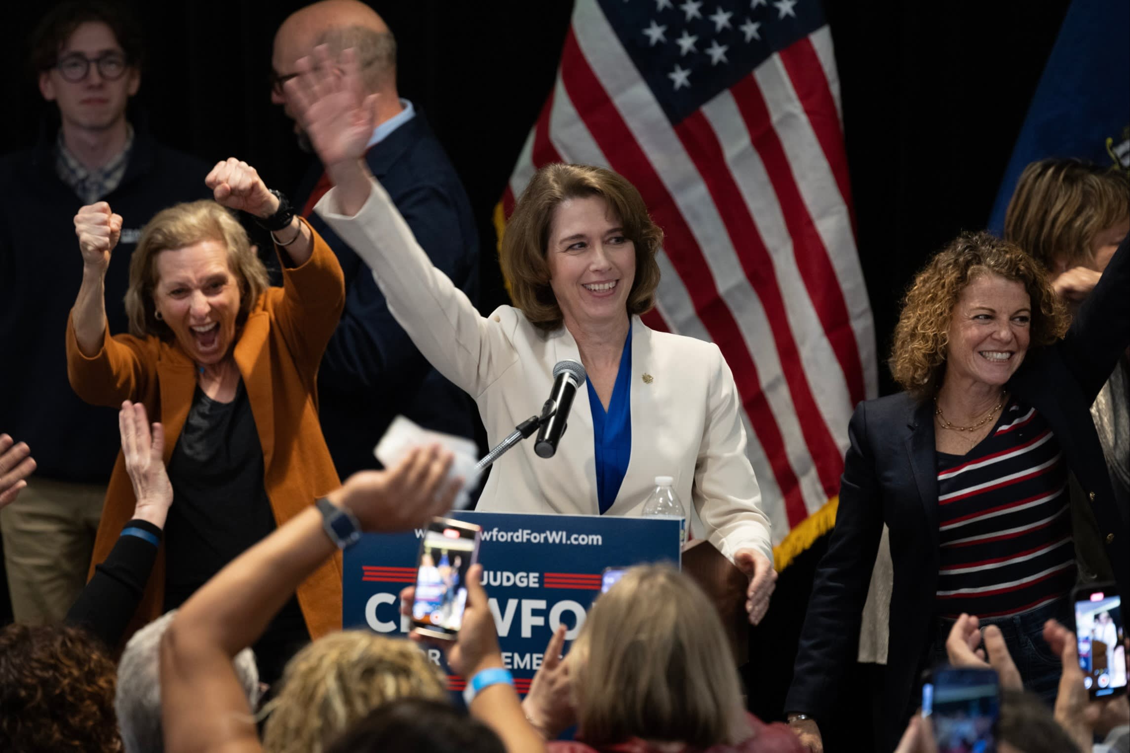 Susan Crawford, flanked by Wisconsin Supreme Court justices, accepts victory in her race for Wisconsin Supreme Court justice