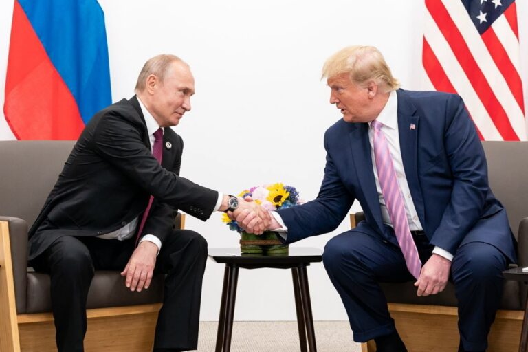 Russian President Vladimir Putin shakes hands with US President Donald Trump in 2019