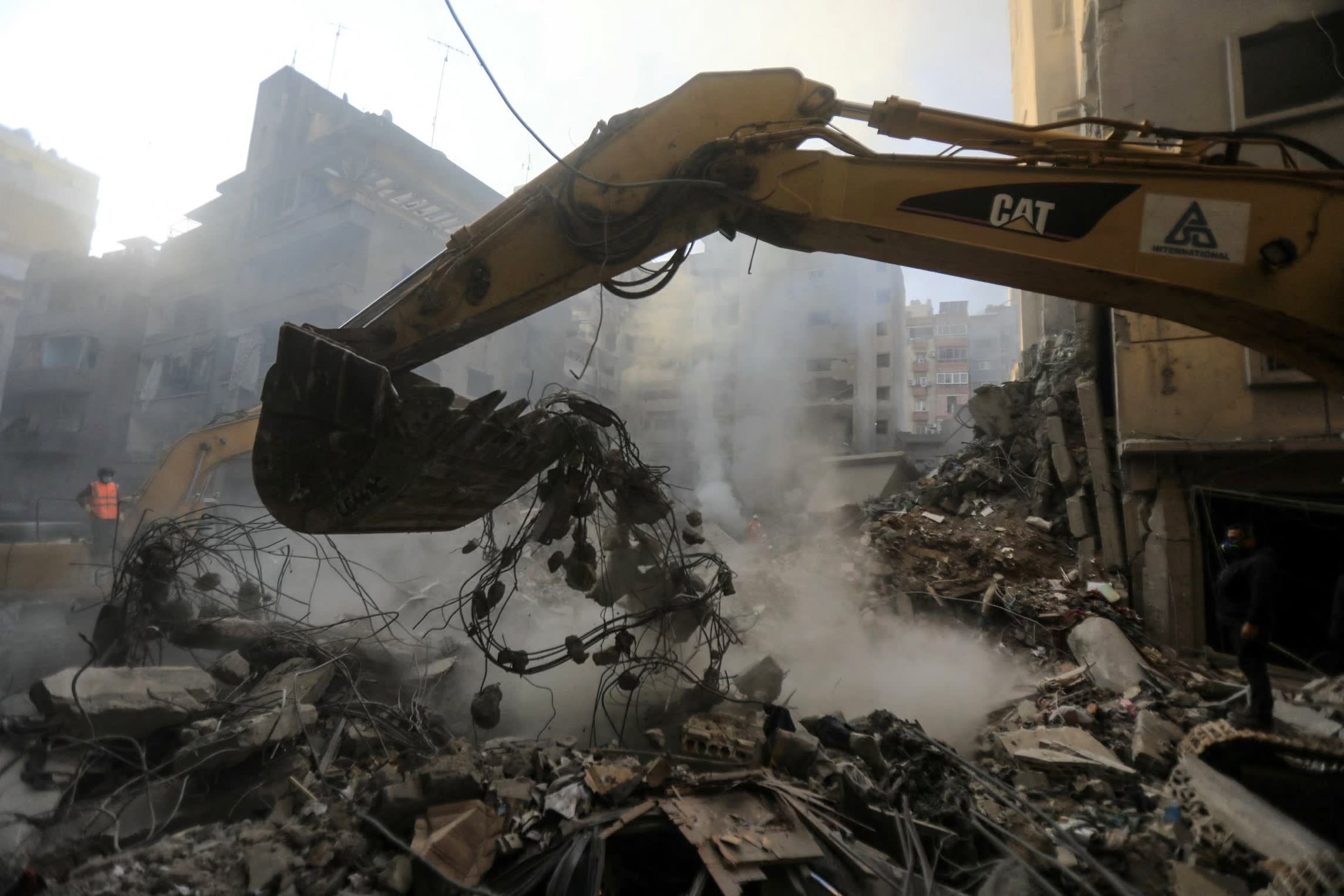 A digger moving some rubble with its scoop