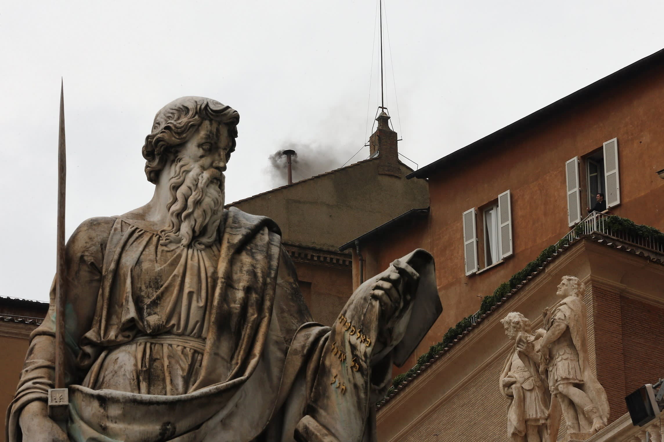 Black smoke rises from the chimney on the roof of the Sistine Chapel