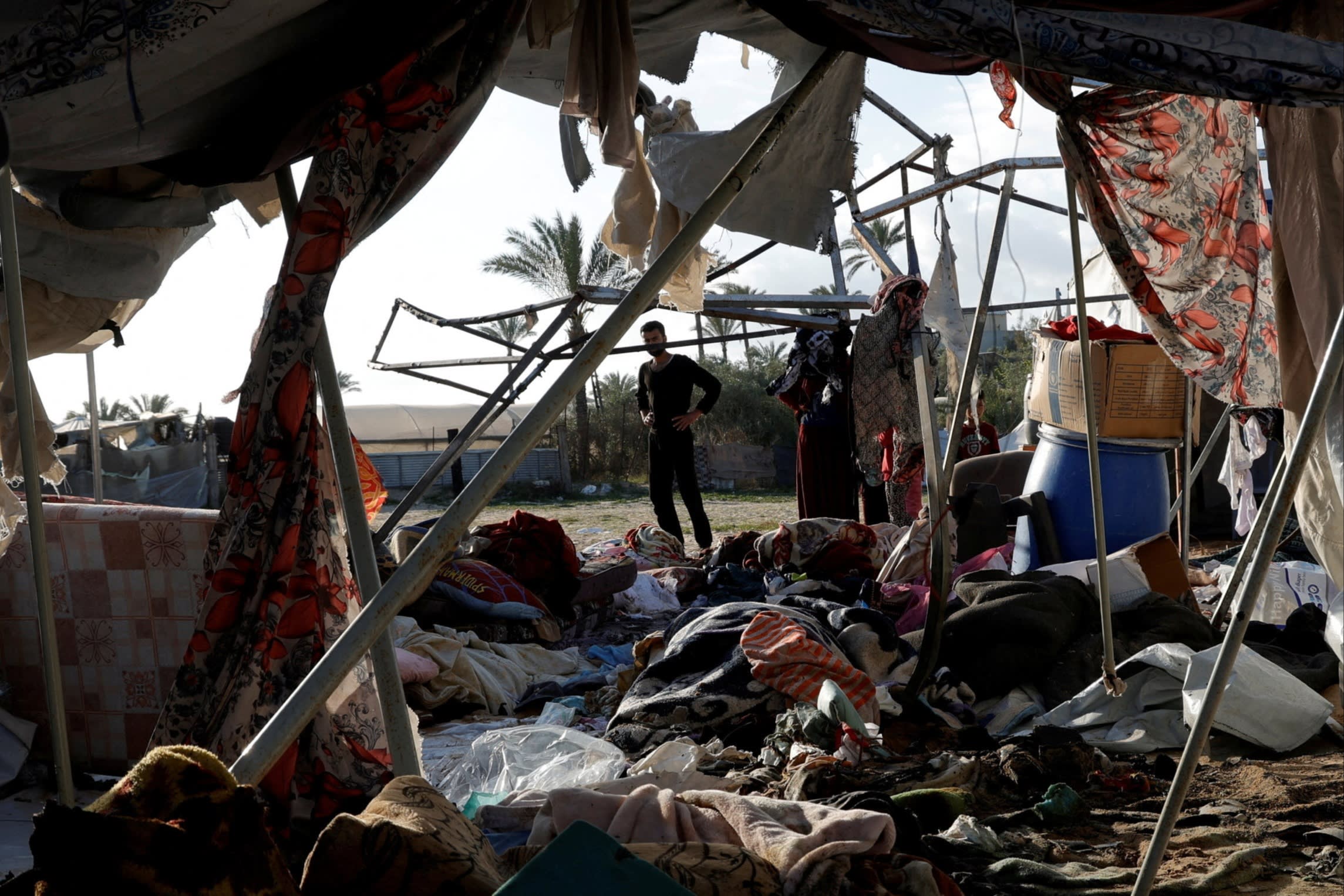 Palestinians inspect the damage from an Israeli strike at a site sheltering displaced people in Khan Younis, Gaza on April 15 2025