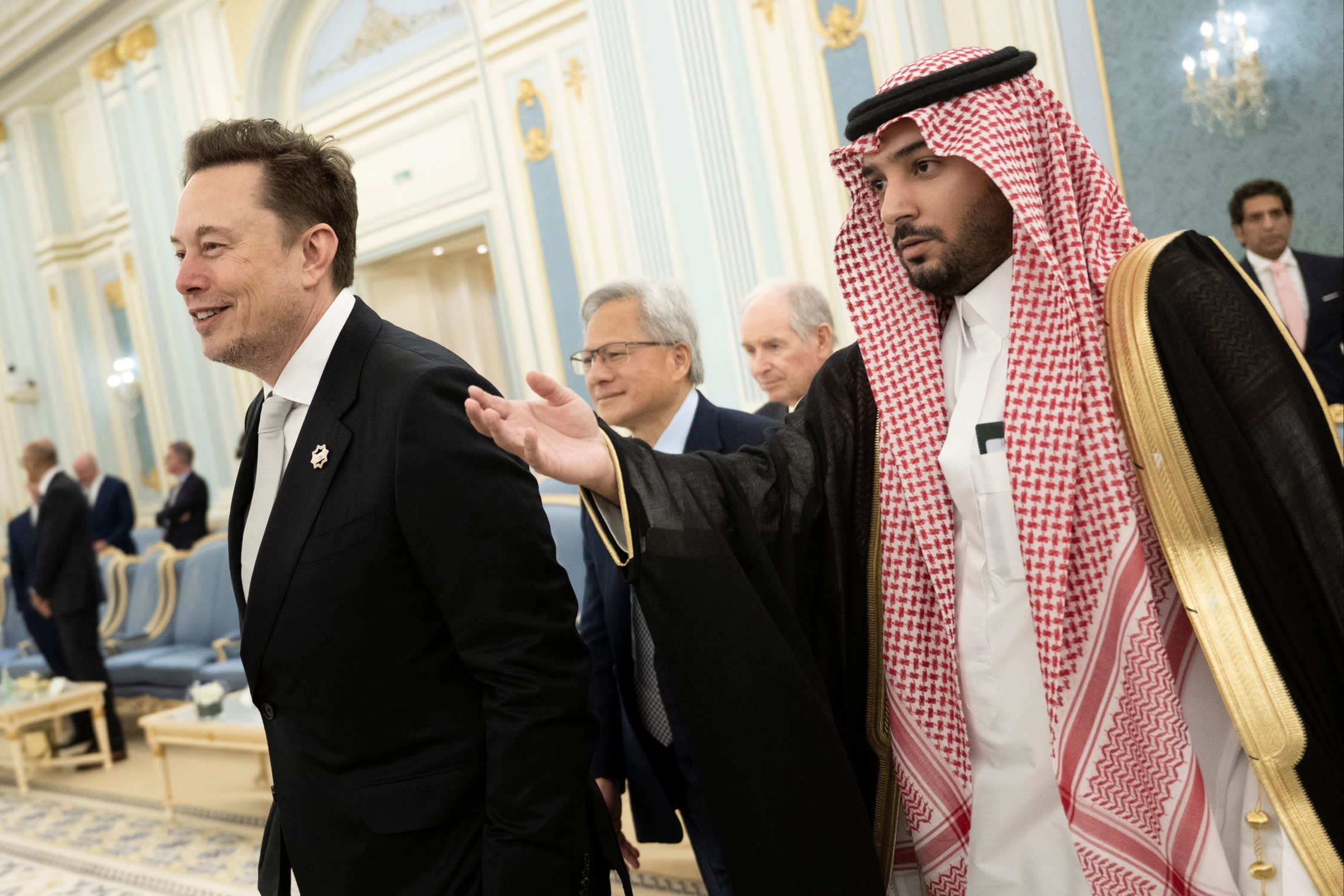 Senior Advisor to the US President Elon Musk (L) and Nvidia CEO Jensen Huang (C) are directed to greet the Saudi Crown Prince