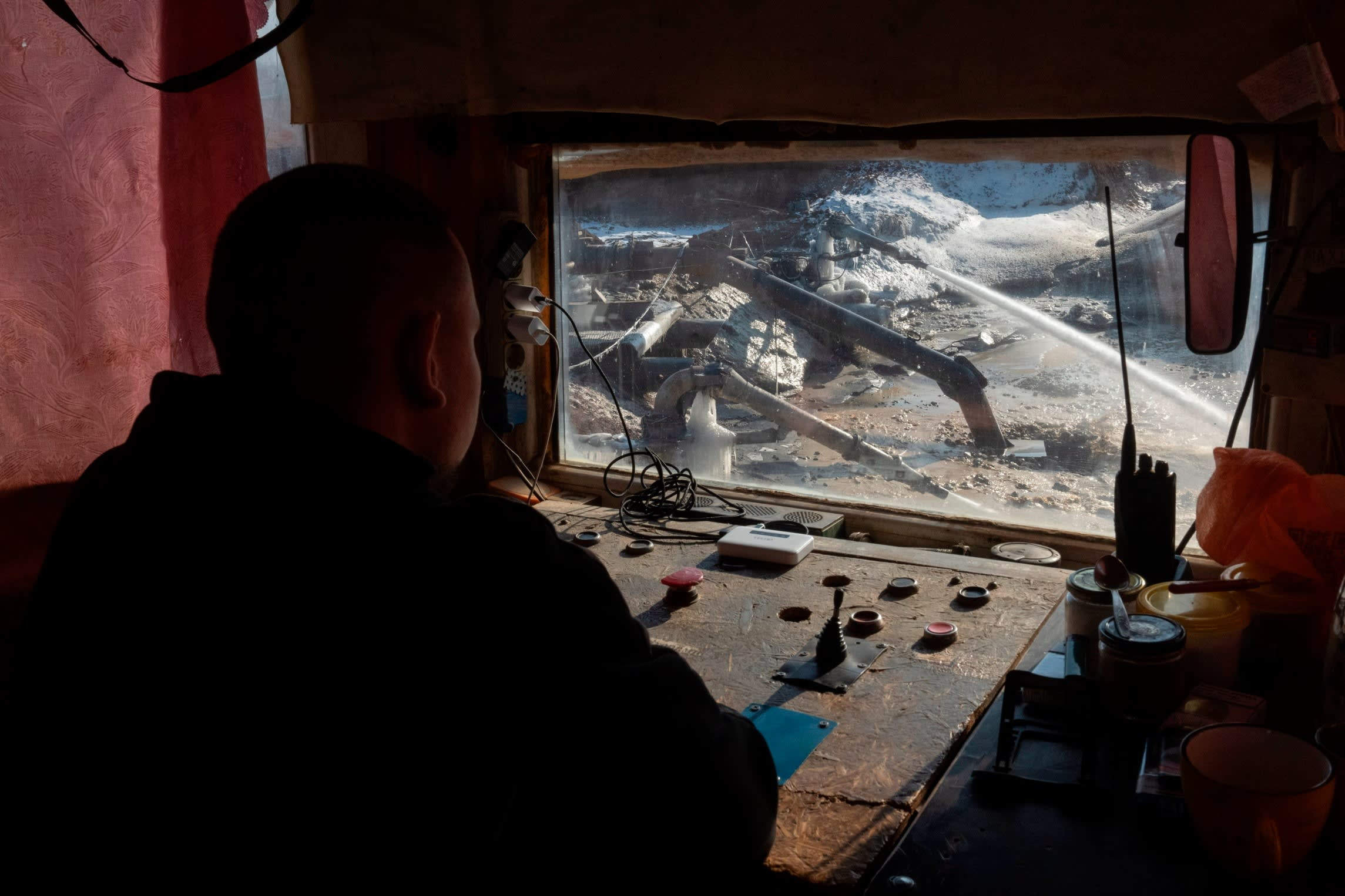 A worker controls extraction of ilmenite, a key element used to produce titanium, in an open pit mine in the central region of Kirovohrad, Ukraine,
