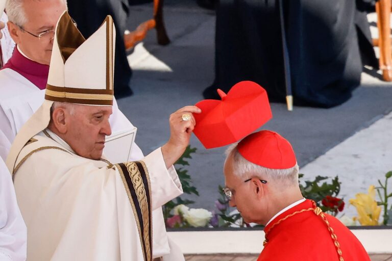 Pope Francis puts the red biretta on the head of new cardinal Robert Prevost during a consistory in St Peter’s Square at the Vatican, September 30 2023