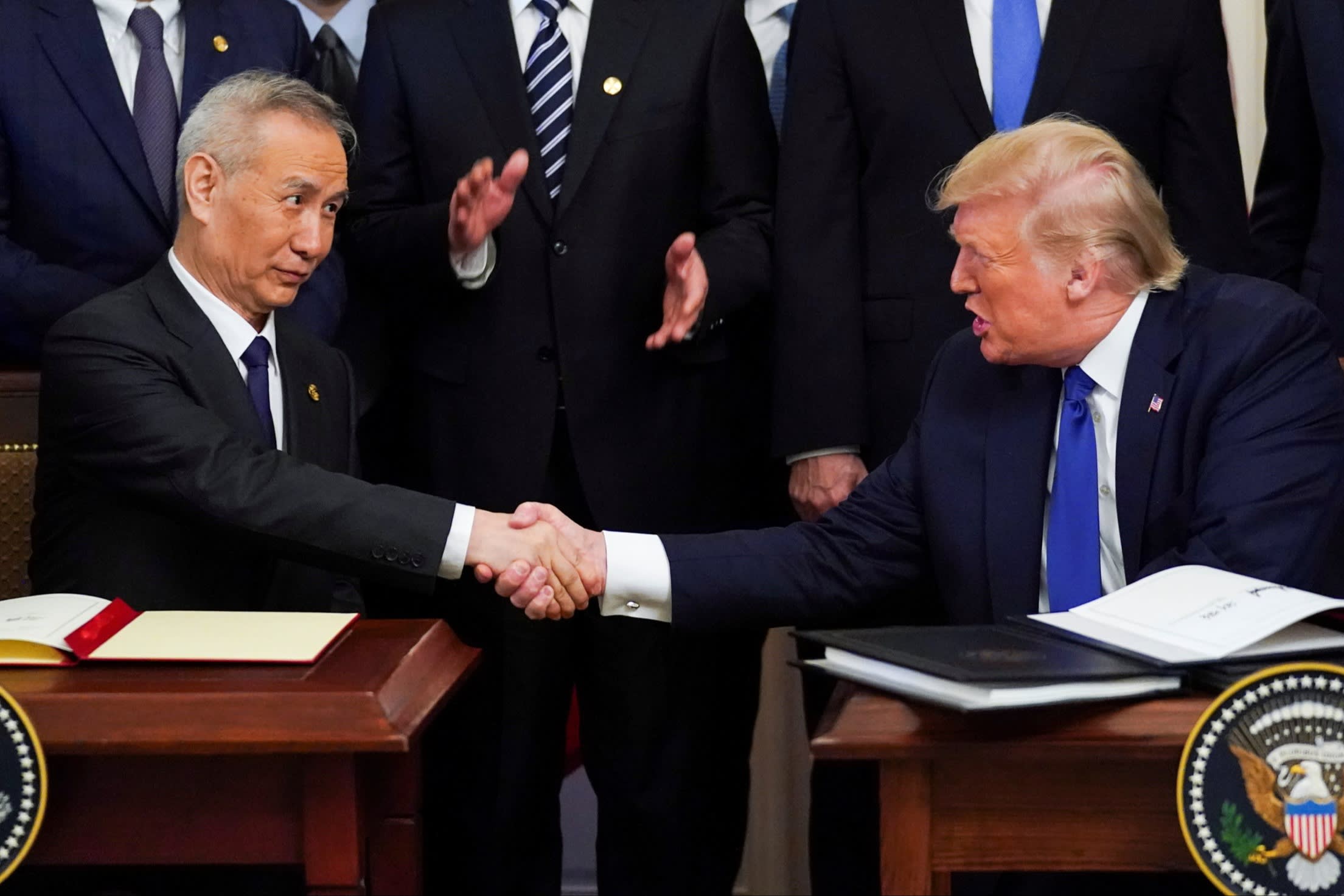 Chinese vice-premier Liu He and US President Donald Trump shake hands after signing a ‘phase one’ trade deal in 2020