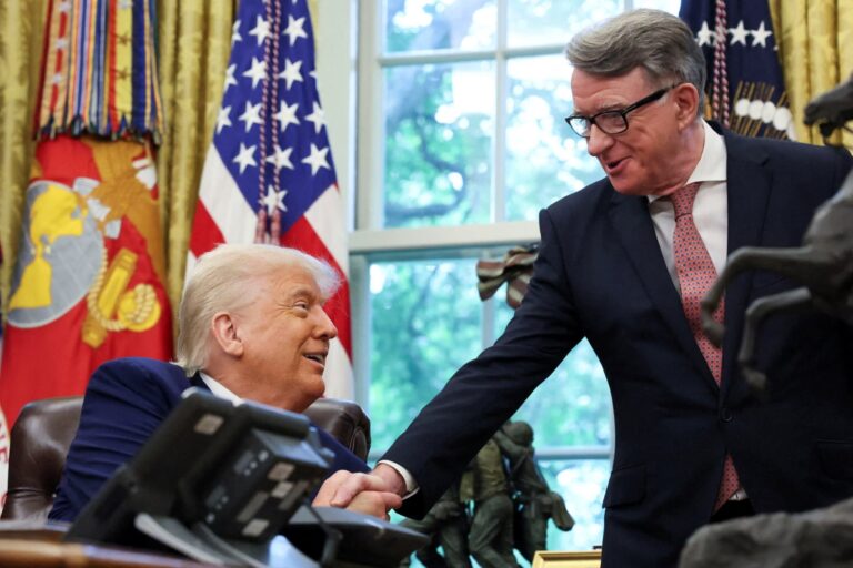 Trump shakes hands with Britain’s ambassador to the United States, Peter Mandelson after announcing a trade deal with the U.K., in the Oval Office
