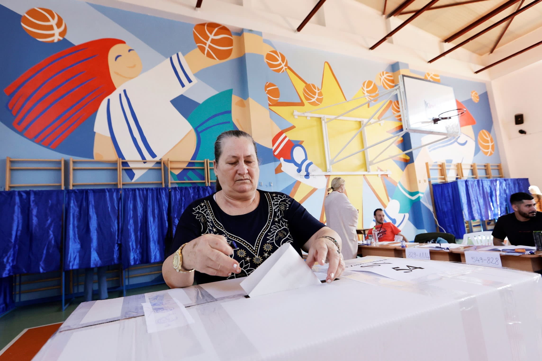 A woman in Bucharest votes in the first round of Romania’s rerun presidential election