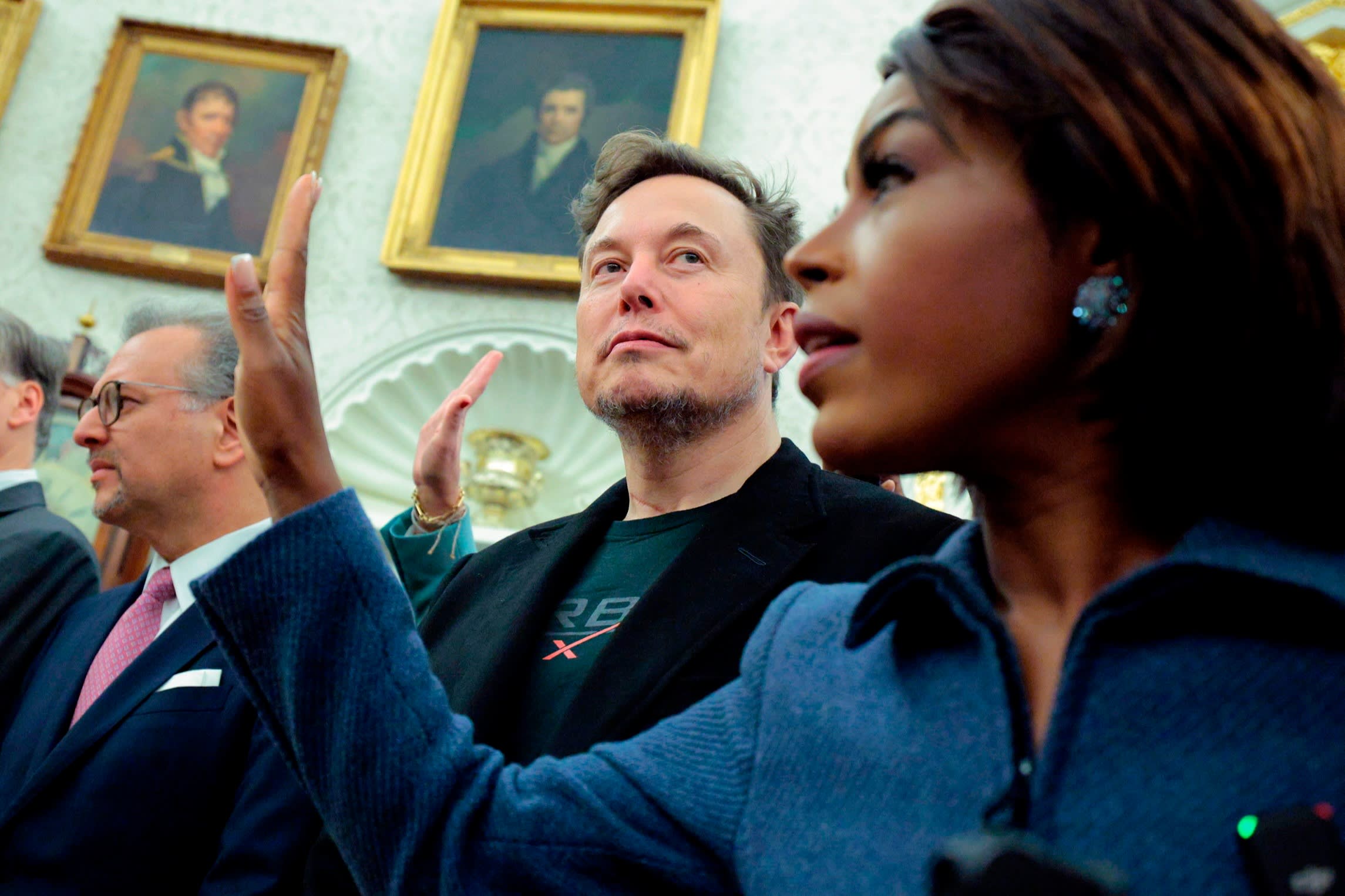 Tesla CEO Elon Musk, centre, looks on during a meeting between President of South Africa Cyril Ramaphosa