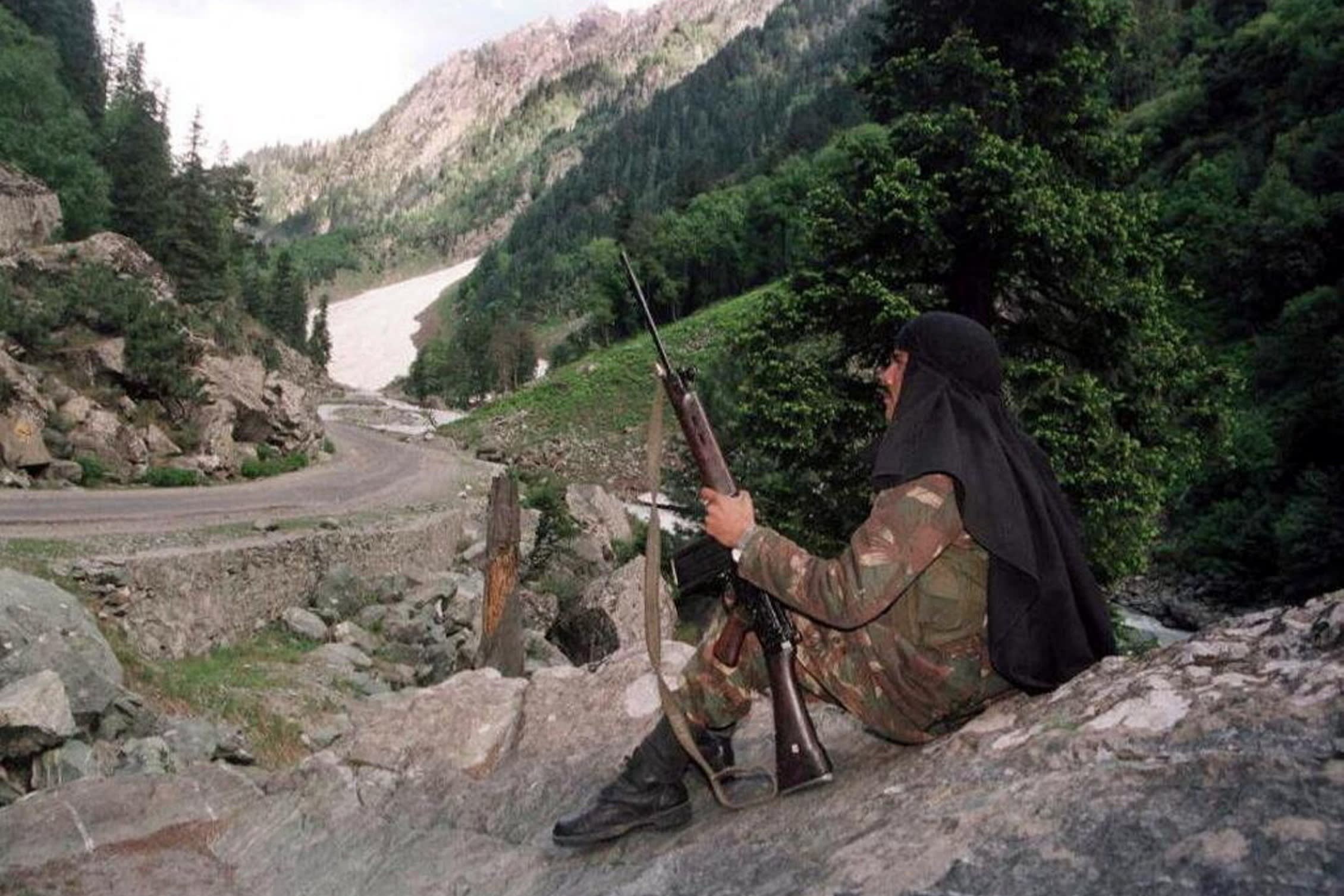 A soldier positions himself on a deserted road leading towards Kargil in India’s troubled province of Kashmir in 1999