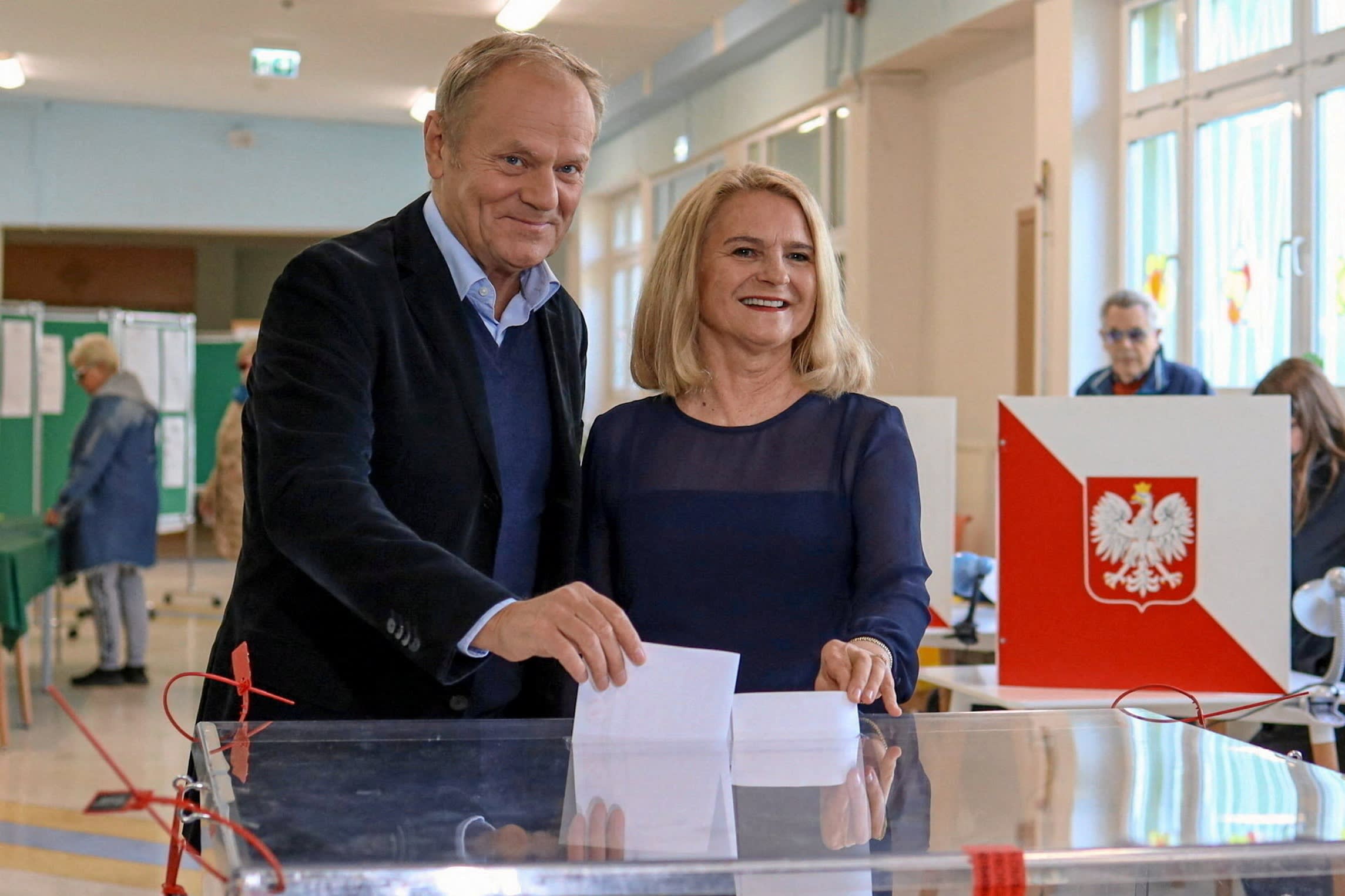 Polish Prime Minister Donald Tusk and his wife Malgorzata vote during the first round of the presidential election