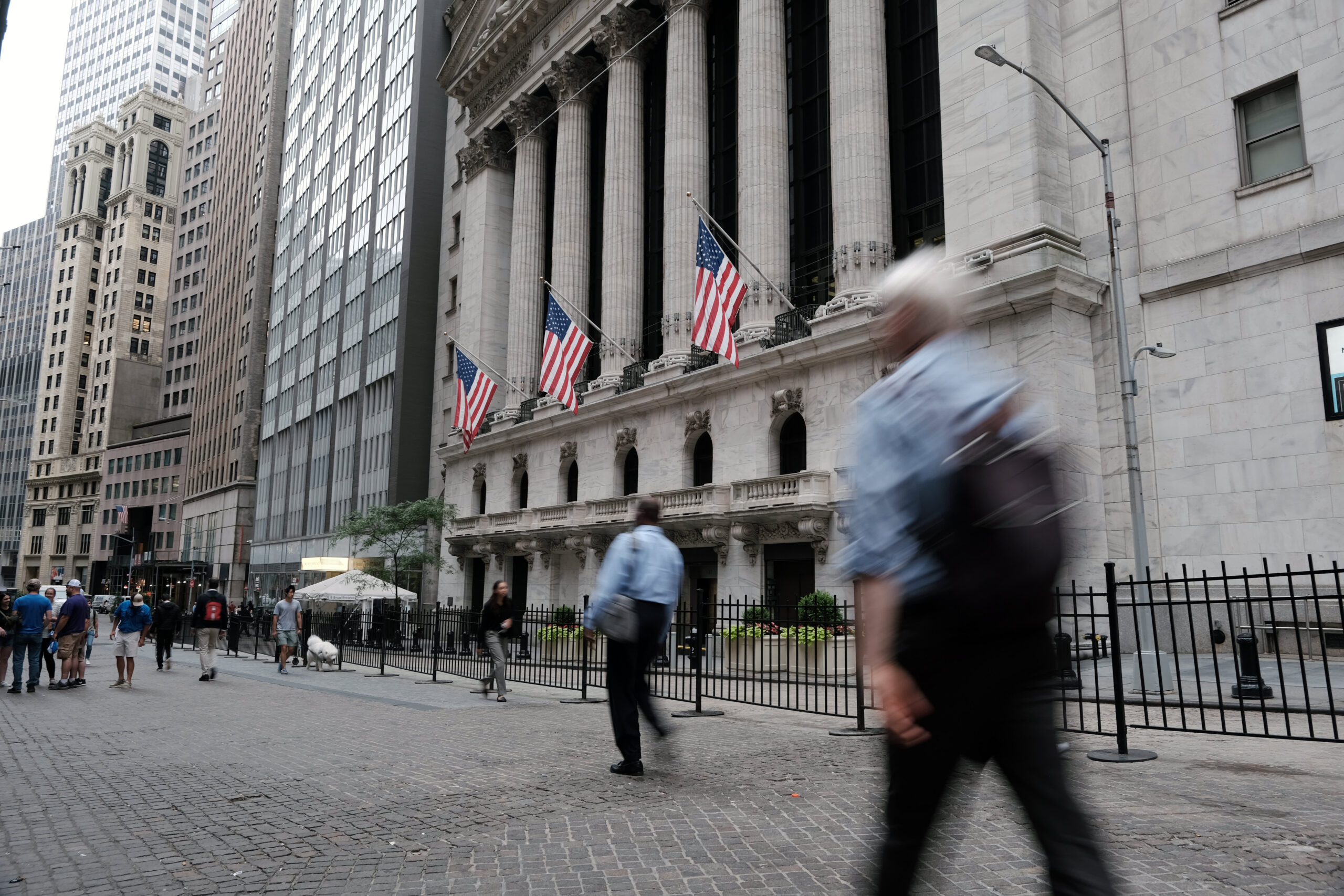 People walk by the NYSE in New York City.