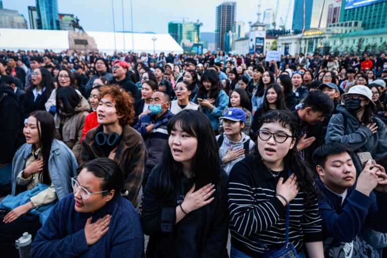 People sing during a protest calling for the resignation of Mongolia’s Prime Minister Luvsannamsrain Oyun-Erdene at Sükhbaatar Square in Ulaanbaatar, Mongolia on May 21 2025