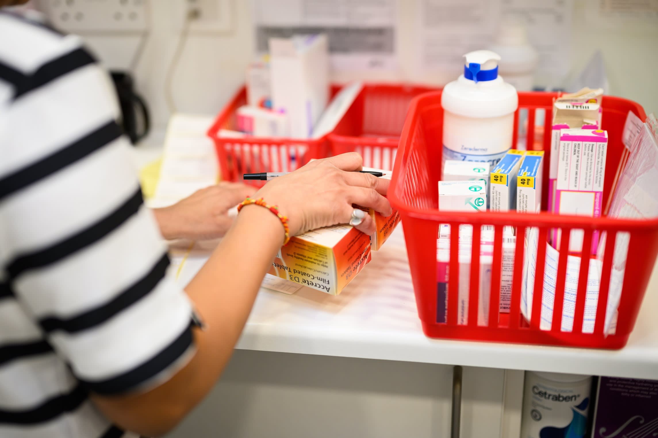 A pharmacist prepares a prescription at the Keencare pharmacy in the UK