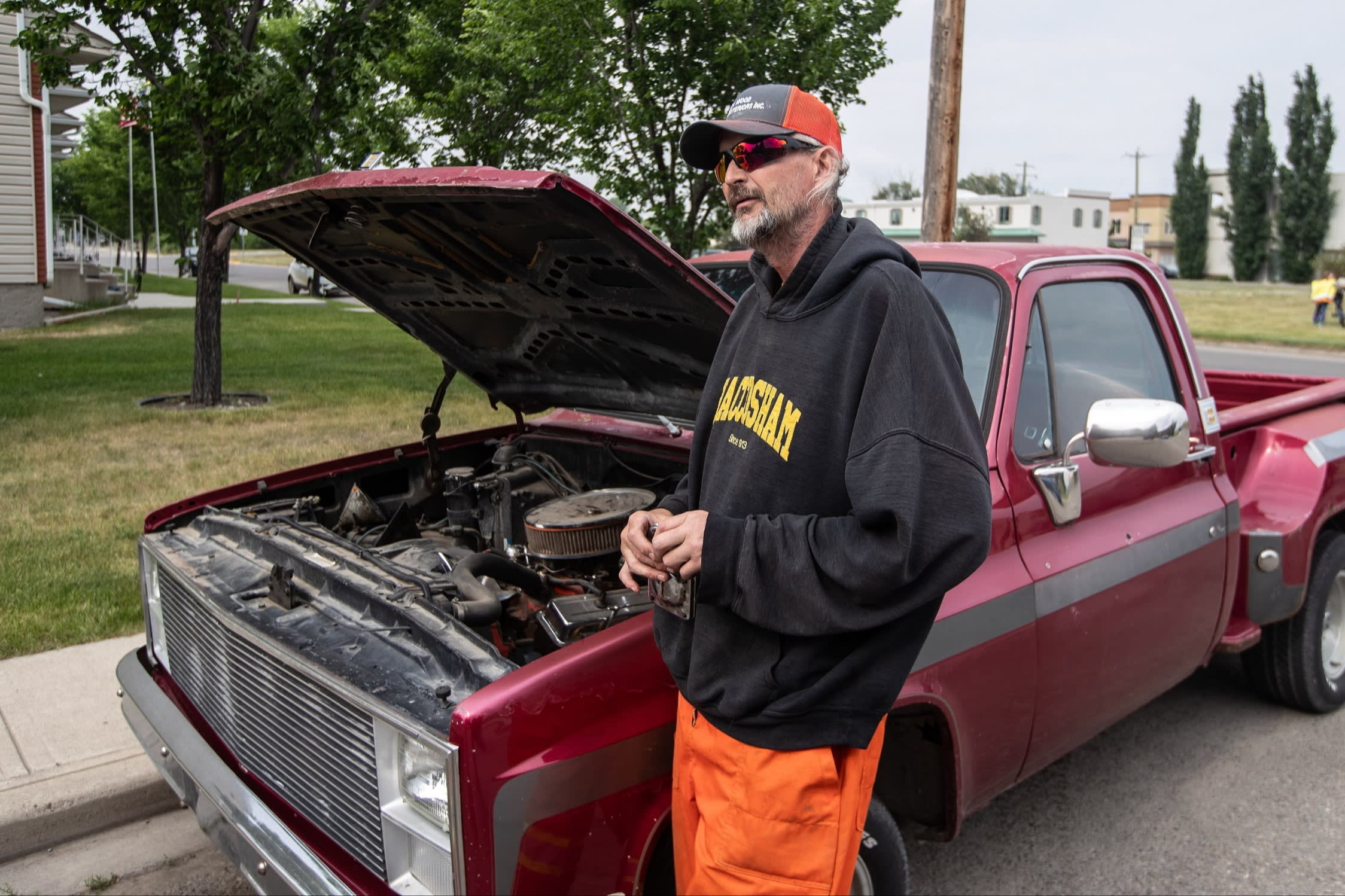 Roger Bablitz stands with his truck he was working on