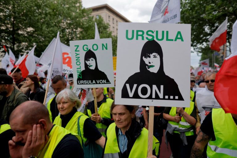 The crowd is carrying banners referring to European Commission president Ursula von der Leyen