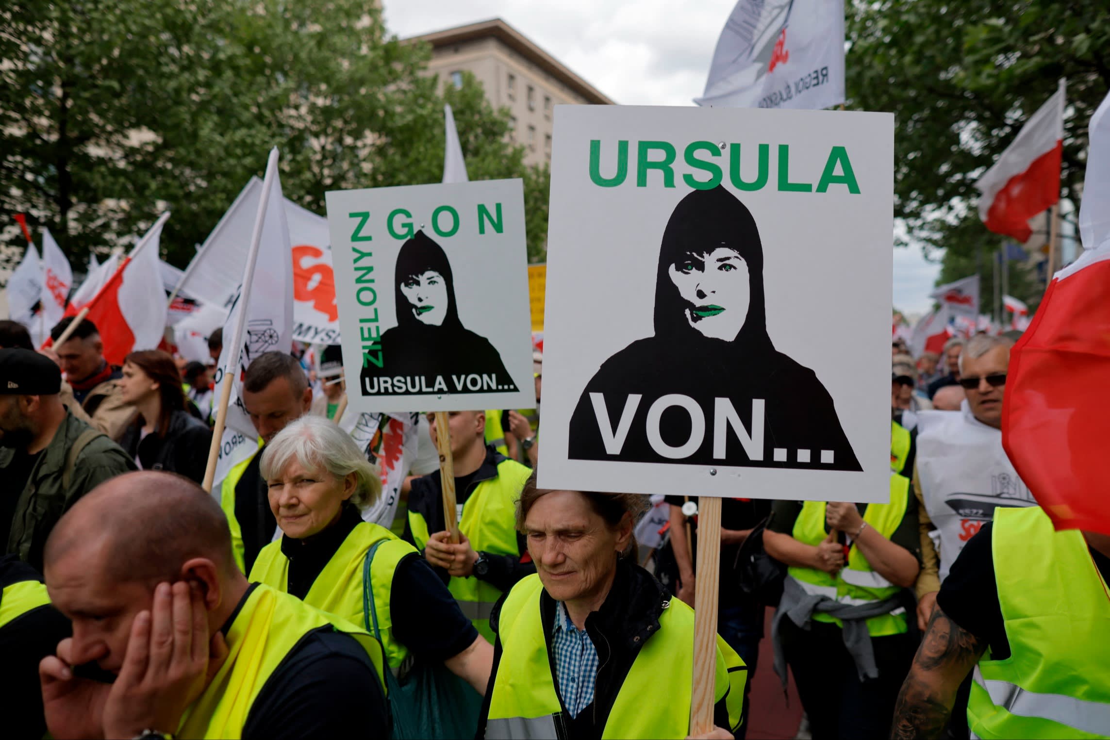 The crowd is carrying banners referring to European Commission president Ursula von der Leyen