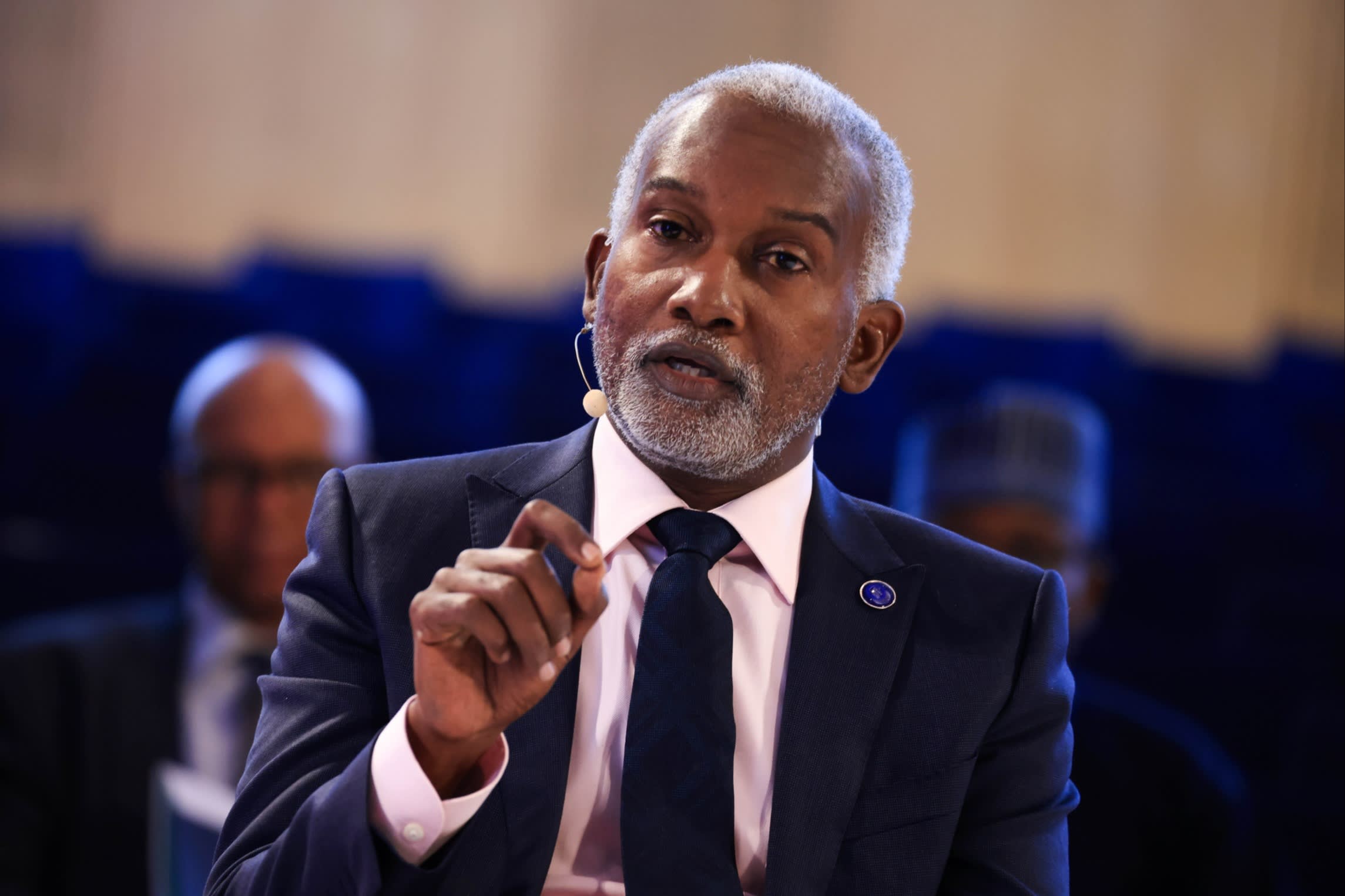 Yusuf Tuggar, Nigeria's foreign affairs minister, is speaking at the Berlin Global Dialogue in Berlin, Germany. He is wearing a suit and a tie, with a microphone attached to his face.