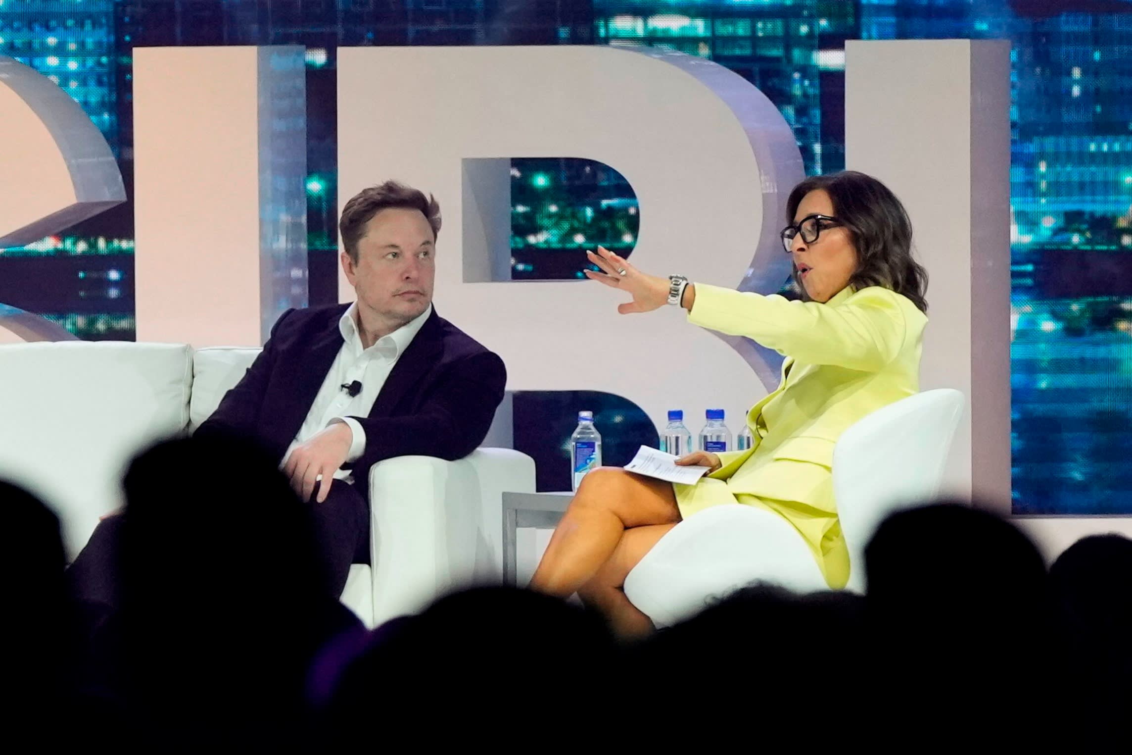 Elon Musk and Linda Yaccarino on stage at a conference in 2023