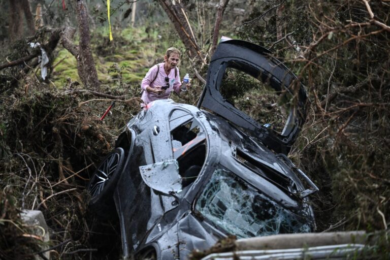 A volunteer looks for the missing, following the severe flash flooding that swept roads and property during the July 4 holiday weekend.