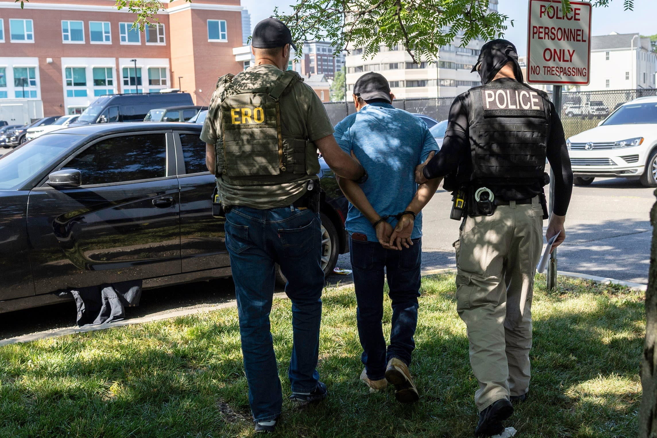 Agents from Immigration and Customs Enforcement (ICE) detain an immigrant