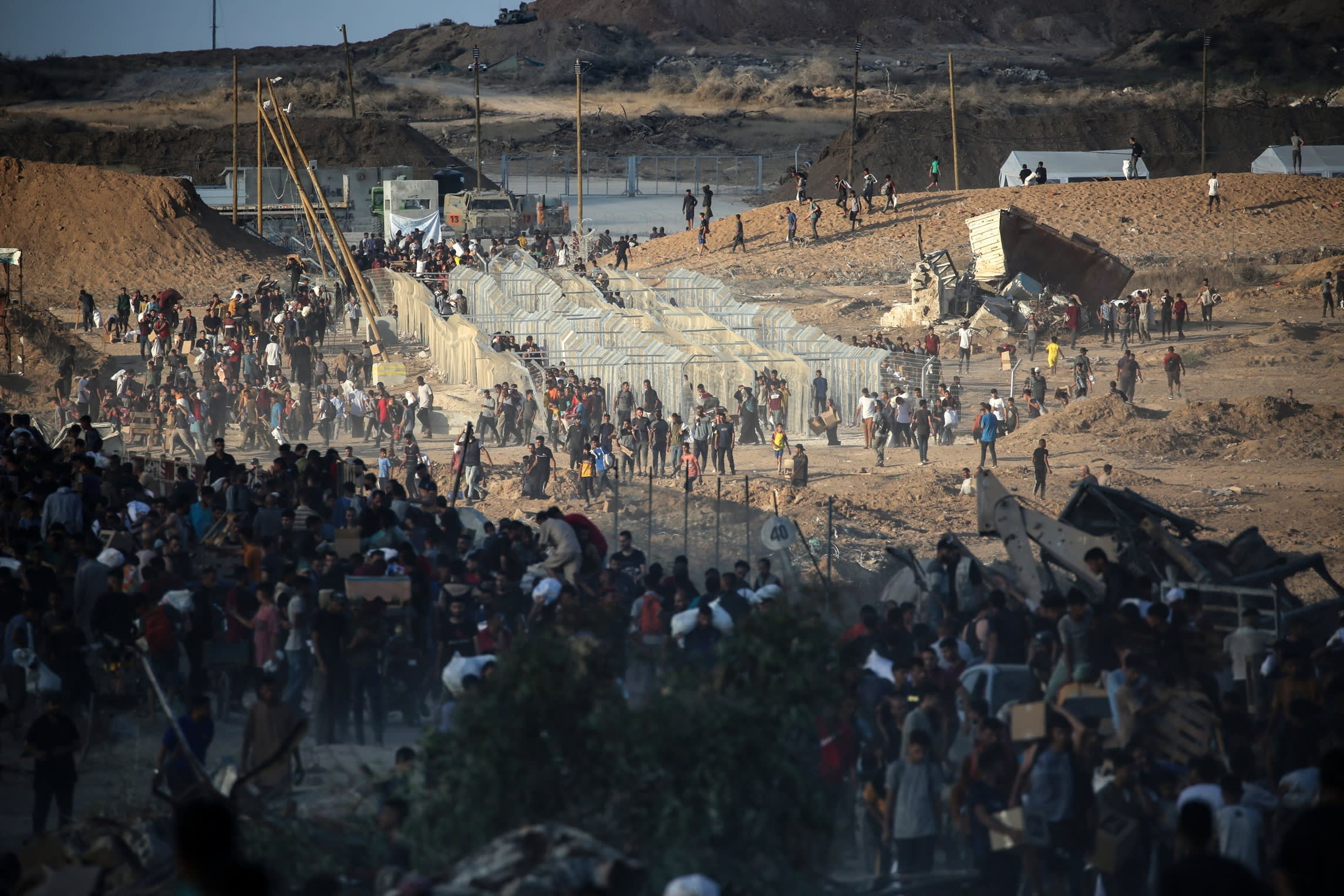 Palestinians gather at an aid distribution point