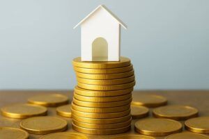 paper house sitting on gold