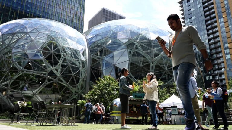 Amazon laying off about 14,000 corporate workers as it invests more in AI