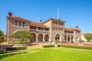 Historic Perth Mint building exterior with sandstone walls and red tile roof.