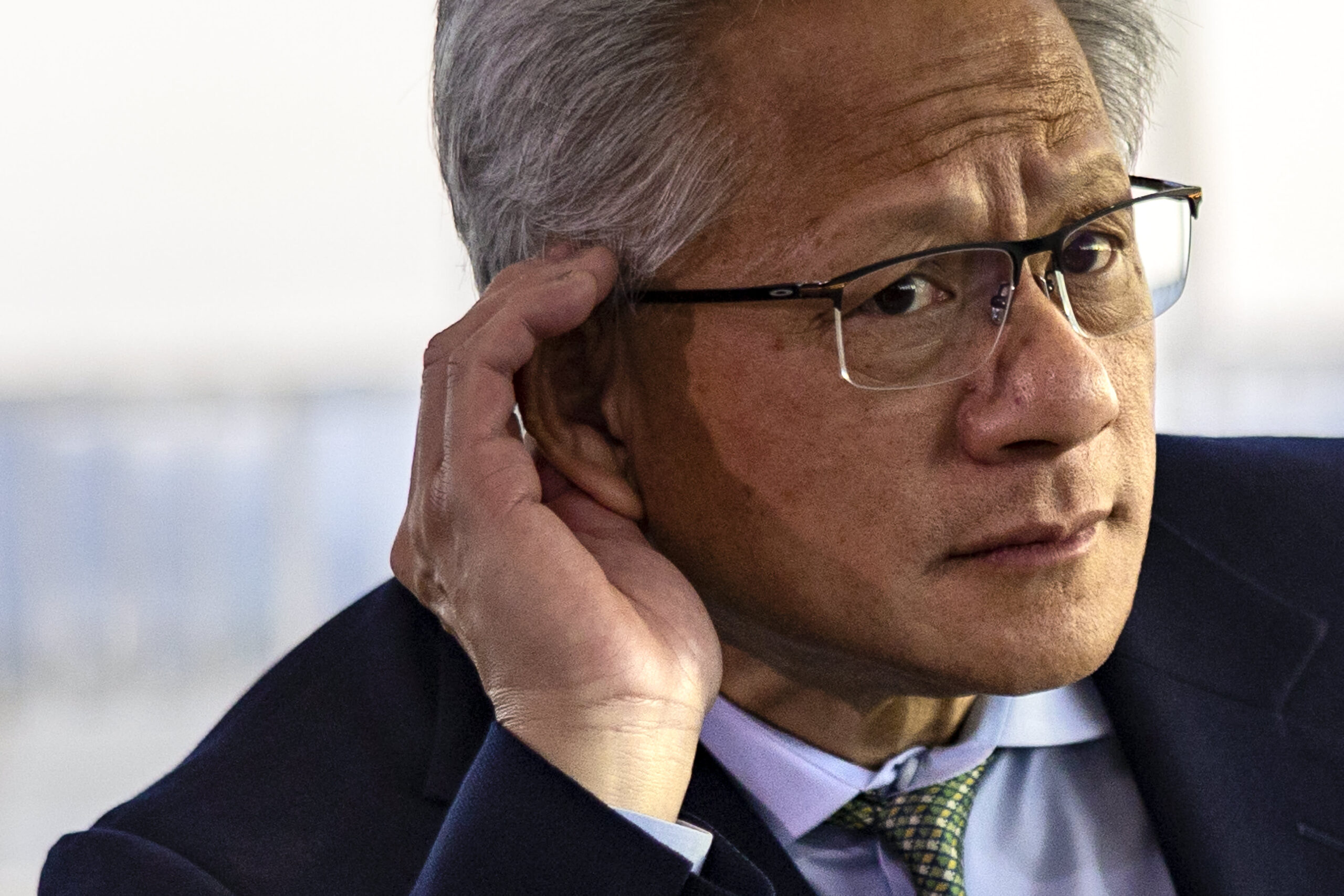 Nvidia CEO Jensen Huang listens to a reporter's question during a press conference at the APEC CEO summit on October 31, 2025 in Gyeongju, South Korea.