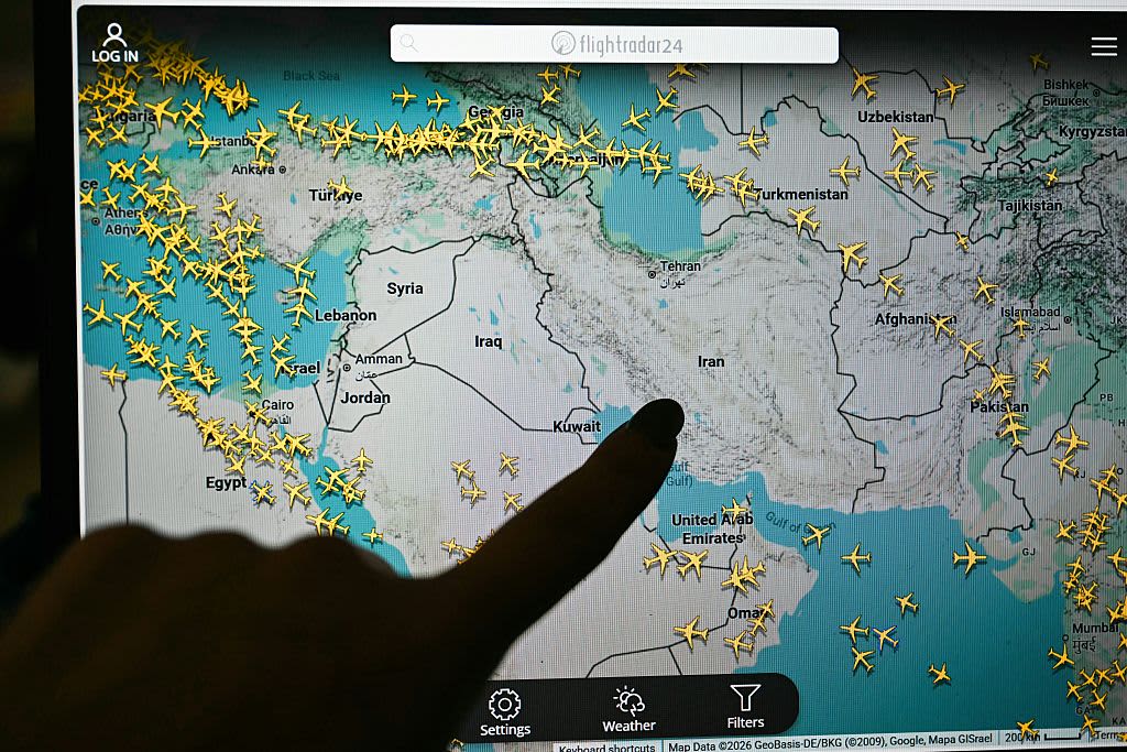 A person points at a page on the Flightradar 24 website thats shows civilian flights avoiding Iranian and Iraqi sky, in Paris on March 1, 2026.