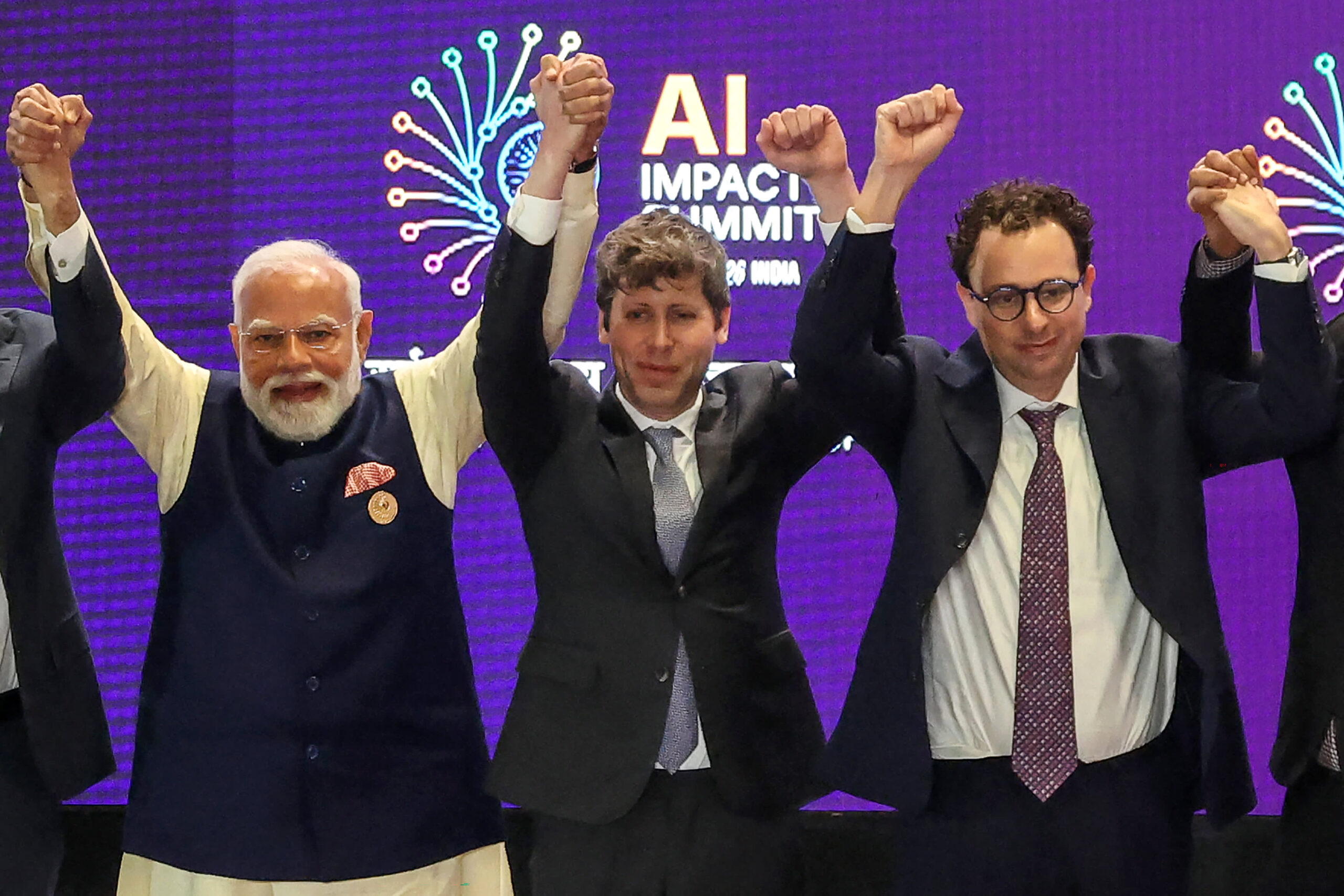 India Prime Minister Narendra Modi, left, with OpenAI CEO Sam Altman, center, and Anthropic CEO Dario Amodei at the AI Impact Summit in New Delhi on Feb. 19, 2026.