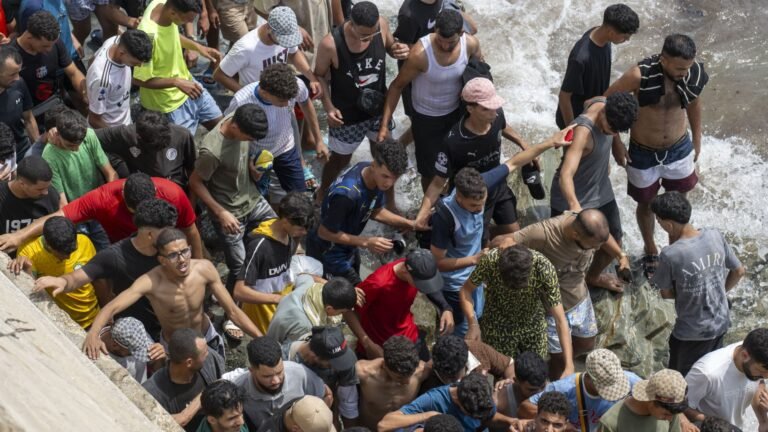 Spain installs floating barrier in North African enclave following border rush by tens of thousands
