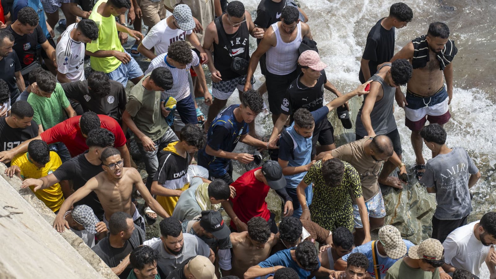 Spain installs floating barrier in North African enclave following border rush by tens of thousands