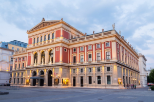 Exterior of the Wiener Musikverein building in Vienna at dusk, the neoclassical concert hall that inspired the obverse design of the Austrian Philharmonic coin