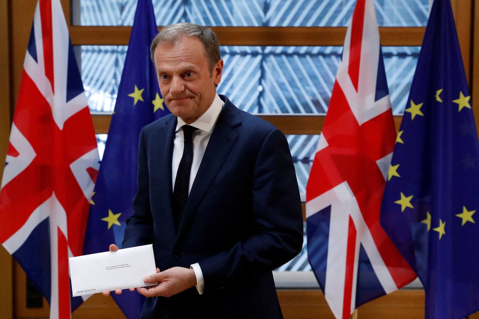 FILE PHOTO: EU Council President Donald Tusk holds British Prime Minister Theresa May's Brexit letter which was delivered by Britain's permanent representative to the European Union Tim Barrow (not pictured) that gives notice of the UK's intention to leave the bloc under Article 50 of the EU's Lisbon Treaty in Brussels, Belgium, March 29, 2017.