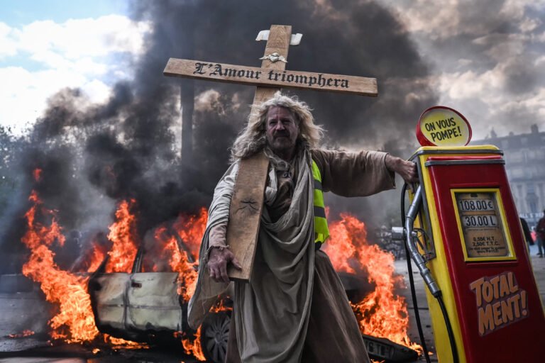 Protesters march through central Paris amid fires, smoke, police deployments and clashes during nationwide demonstrations against the high cost of living, on October 17, 2026 in Paris, France.