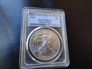 2017 American Silver Eagle encapsulated in a PCGS slab displaying the First Day of Issue label designation alongside the MS-69 grade and certification number